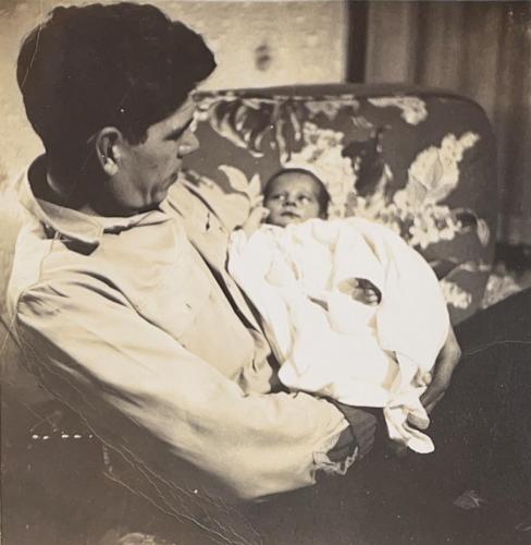 Daddy Gus holds Bobby, who is 12 days old. 