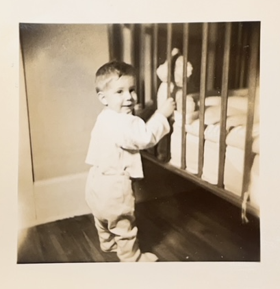 Bobby tries out standing with the help of his crib. (circa 1948)