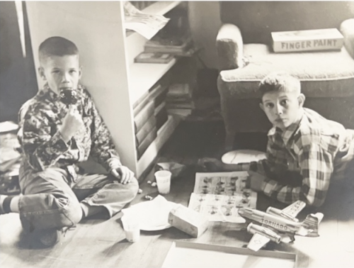 Richard and Robert enjoy snacks and model planes, circa mid 1950s.