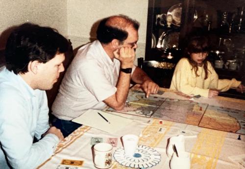 Britt Stephens (brother-in-law,) Bob, and Ashley play Rail Baron at Robbie Smith's house, 1988. Rail Baron, where the game play is building, buying, and selling railroads, was one of Bob's favorite board games, along with Monopoly and Risk.