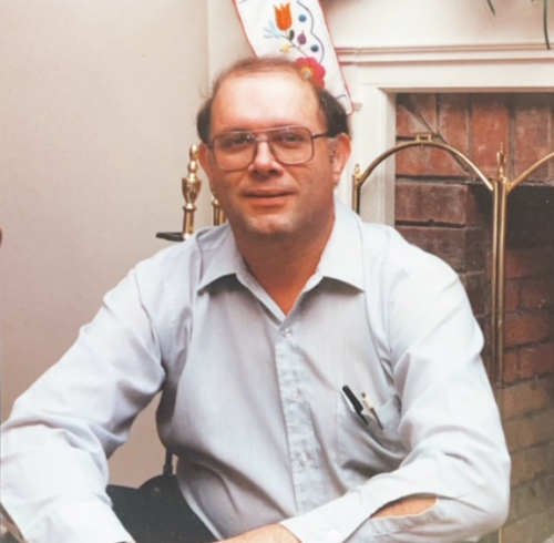 Bob poses in front of the fireplace at Christmastime, circa 1988 or 1989.