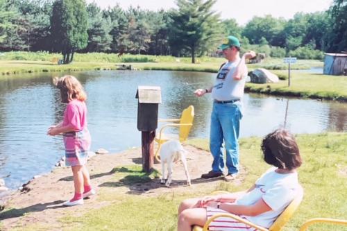 Another summer in Cadillac means another visit to Johnny's Farm, where Bob and Ashley feed the rainbow trout in the stocked pond, July 1990.