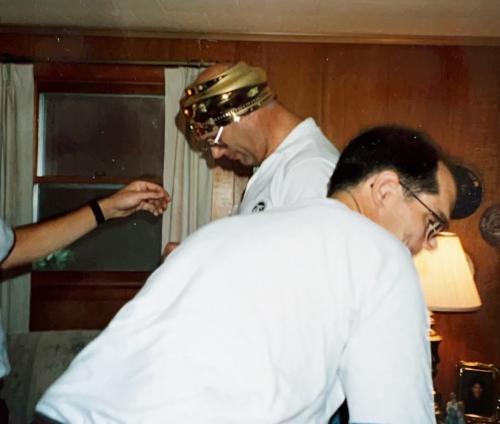 Quintessential Bob humor: a light fixture worn as a hat with DIck, Cadillac, July 1994.
