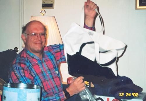 Bob receives another beloved canvas bag, his signature tote! Christmas Eve, 2002, Britt and Vivian's home, Nashville, Tennessee.